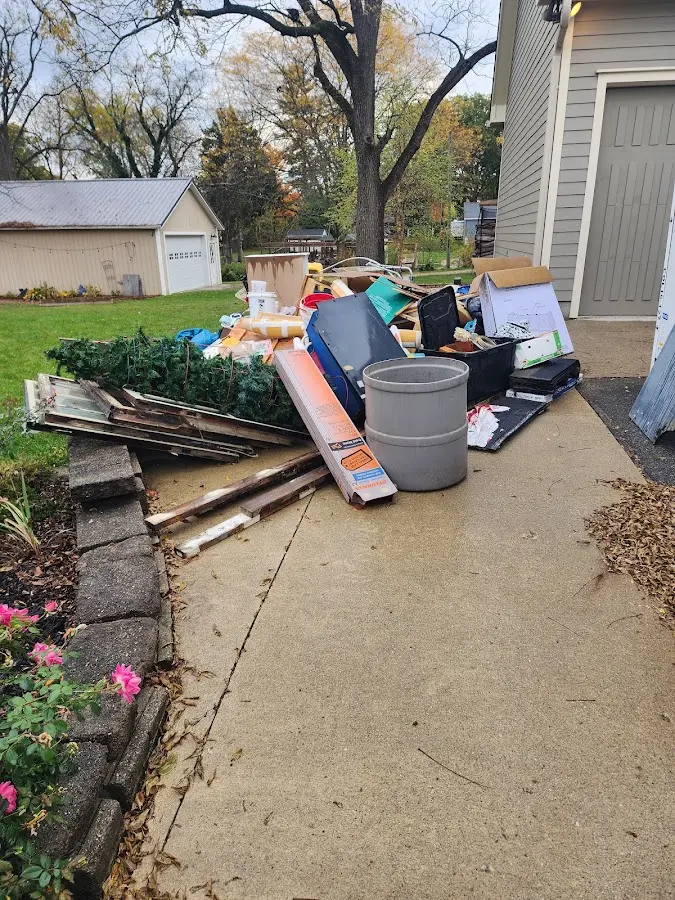 Dumpster being loaded with debris for 10 Yard Dumpster Rental in South Jordan